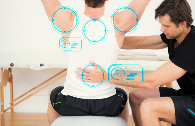 A physiotherapist in Sharjah assessing a patient's posture and back mobility during a rehabilitation session.