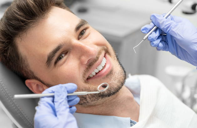 A patient undergoing a comprehensive dental examination with modern equipment at a clinic offering expert Dentistry in Sharjah.