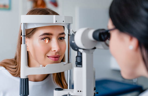 A patient undergoing a slit-lamp eye examination at an Ophthalmology Hospital in Sharjah.