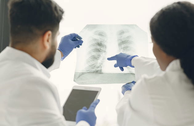 Doctors reviewing a chest X-ray to support accurate diagnosis through Radiology & Diagnostic Imaging in Sharjah.