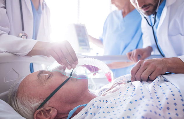 Team Doctors Putting Oxygen Mask Male Senior Patient Face (1)