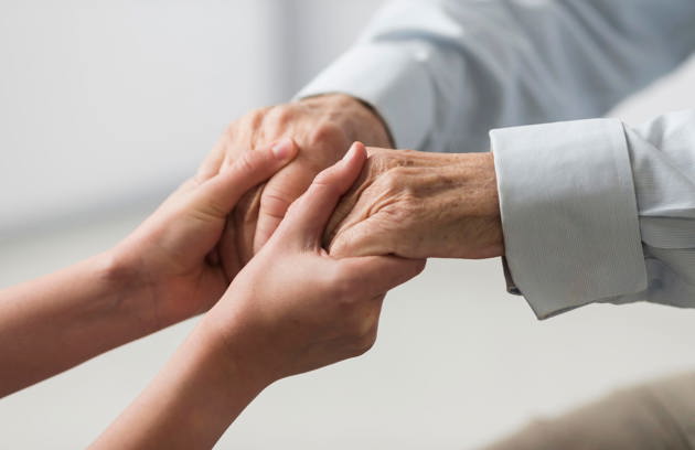 Nurse Holding Senior Man S Hands Sympathy